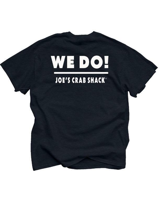 The image shows a black, short-sleeved t-shirt laid flat, displaying the back side. Printed in bold white letters across the upper back of the shirt is the phrase “WE DO!” Below this, in smaller white font, reads “JOE’S CRAB SHACK.” 