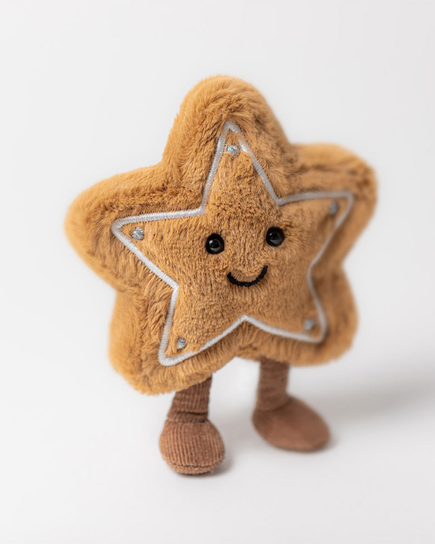 Star-shaped plush toy with a smiling face standing on a white background