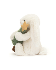White plush toy resembling a penguin holding a green tree on a white background