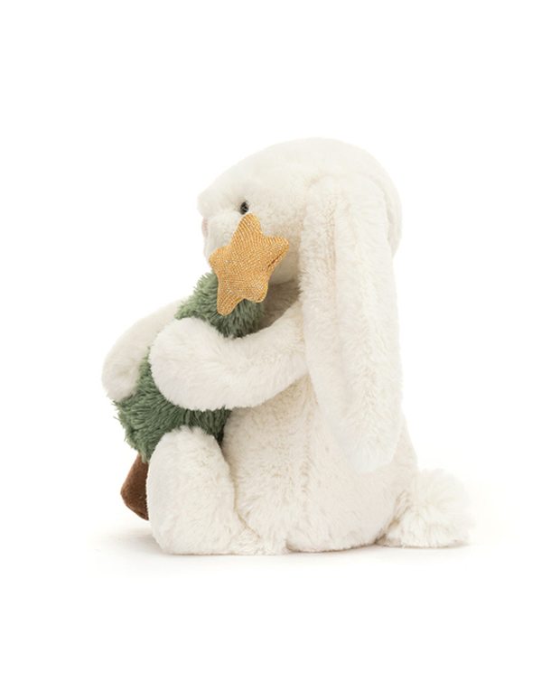White plush toy resembling a penguin holding a green tree on a white background