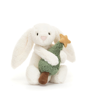 White plush bunny holding a small green tree with a gold star on a white background