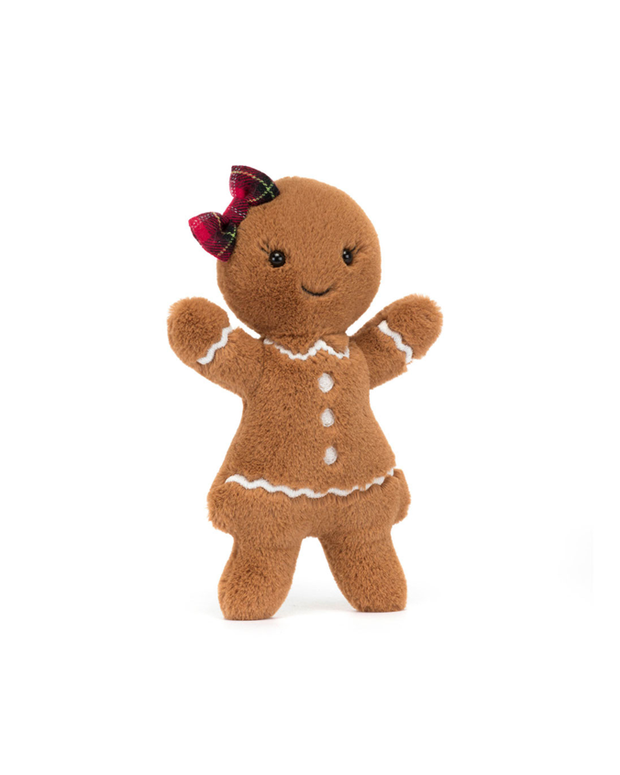Stuffed gingerbread toy with a bow on a white background