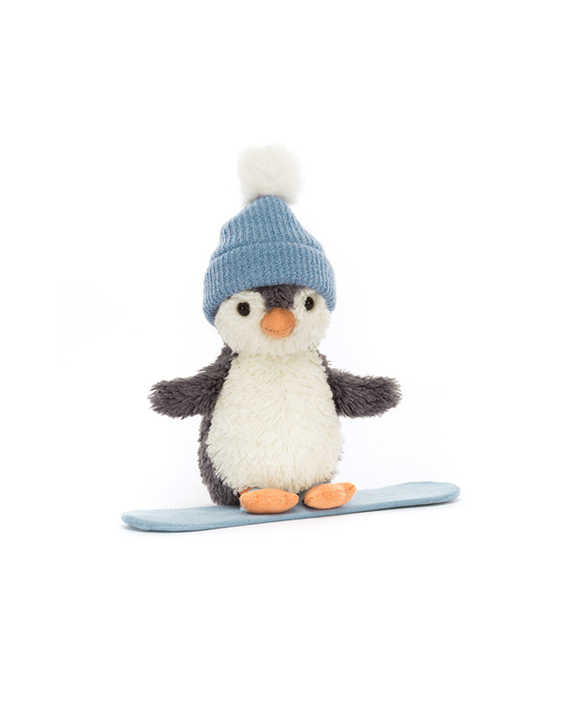 Stuffed penguin toy wearing a blue hat and sitting on a blue snowboard against a white background