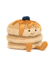 A plush 3-stacked pancake toy sitting against a white background with legs and feet out in front, including maple syrup and blueberries on top.