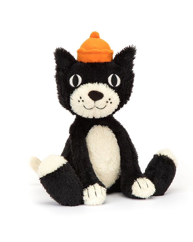 A black cat plush sitting against a white background, with a white belly and snout, and an orange beanie hat.