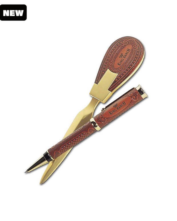 Metallic gold accent letter opener and pen wrapped in tan leather both with King Ranch text and logo. The craftsmanship of the pen and letter opener suggests a sophisticated, elegant writing instrument possibly intended for gift-giving or as a collector’s item. "NEW" text on the op right of the image on a white background.