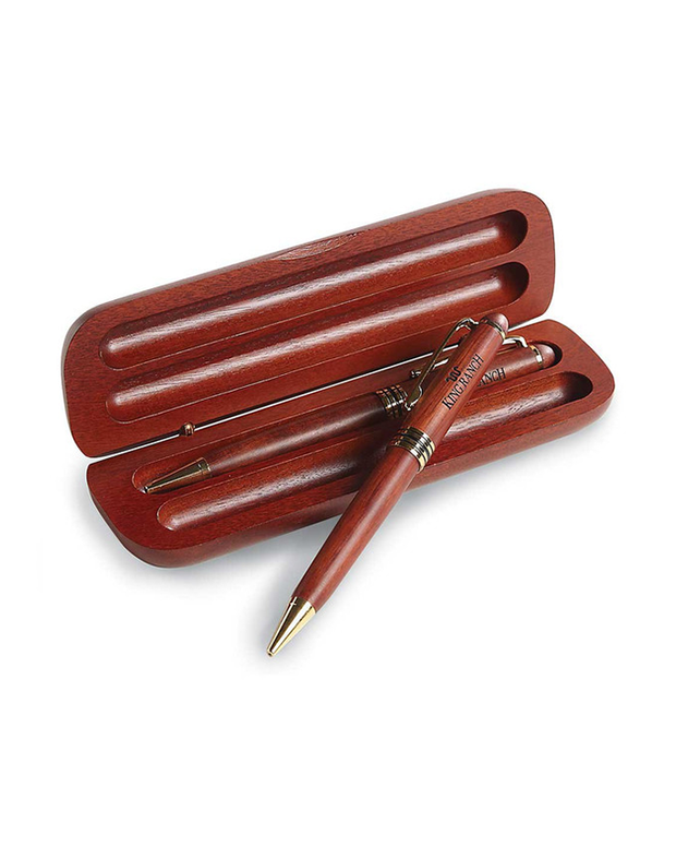 A wooden pen and pencil with a matching wooden case resting on a white background.  he case has two recessed areas shaped to fit the pen and pencil,  both made of a similar polished wood with metallic accents.