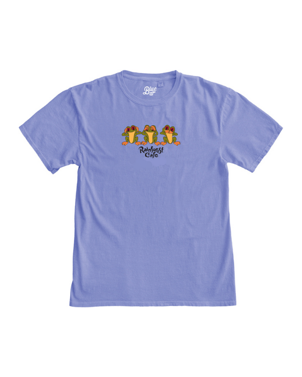 A light blue crewneck T-shirt with a graphic of three frogs with their hands on their heads, and the words "Rainforest Cafe" printed under it. The background is plain white.