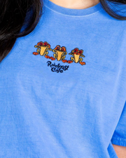 Blue t-shirt with cartoon frog design and 'Rainforest Cafe' text