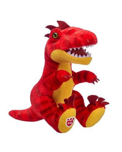 A plush toy of a red and yellow dinosaur with green eyes, sharp white teeth, and a tag on its foot against a white background. The plush toy appears to be predominantly red with a yellow underbelly. It has an open mouth displaying white, sharp teeth, and green eyes. Small red spikes run down the back of its head, and its claws are also yellow. There’s a tag on one of its feet, although the symbols on the tag are not clearly visible due to the resolution of the image.
