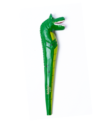 An intricately designed green wood pen, modeled to resemble a crocodile. The pen features a detailed crocodile head with an open mouth and white teeth at the top, and the body of the crocodile, complete with scales and limbs, forms the shaft. The brand name ‘Rainforest Cafe’ is prominently displayed along the side in yellow lettering. The pen is set against a stark white background, highlighting its vibrant green color and unique design.