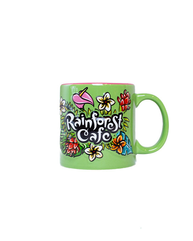 A colorful green mug with "RAINFOREST CAFE" written on the front, surrounded by tropical flowers and leaves. 