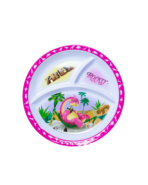 A round, divided children’s plate with a vibrant design. The plate is primarily white and has three compartments. The rim of the plate is decorated with multiple dinosaurs and pink along the edge. In the largest compartment, there is an illustration of a pink brachiosaurs laying next to green palm leaves, with the word ‘ROCKSY’ partially visible. 