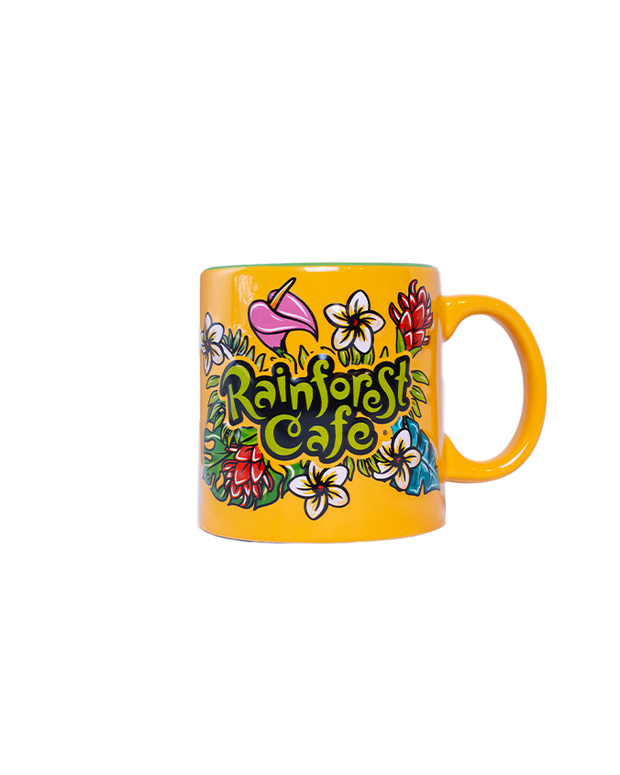 A colorful yellow mug with "RAINFOREST CAFE" written on the front, surrounded by tropical flowers and leaves. 