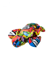 turtle plush with colorful comic patterns containing message bubbles and aquatic animals.