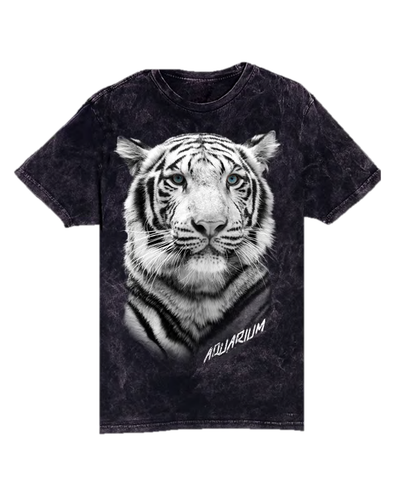A black t-shirt featuring a highly detailed and realistic print of a white tiger’s face on the front. The tiger’s eyes are blue, and it has a focused expression. Below the image of the tiger, the word “AQUARIUM” is printed in white capital letters. The fabric of the t-shirt seems to have a slight texture or pattern to it. 