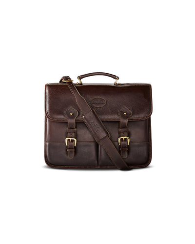 Dark brown leather briefcase against a neutral background. The briefcase features a front flap with two straps and buckle closures, a top handle, and an embossed  King Ranch logo in the center. There is also an adjustable shoulder strap attached to the sides of the briefcase. 