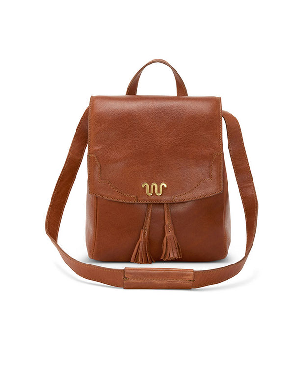 tan leather backpack with brass running w embellishment on snap. two tassels underneath snap flap.