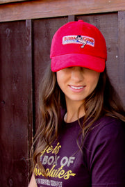 Woman wearing limited edition red Bubba Gump cap with "Life is Like a Box of Chocolates" tee from Bubba Gump.