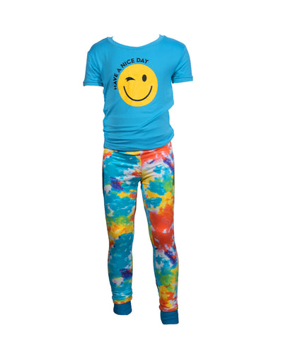 Blue tee with a yellow winking smiley face and "Have a nice day" in black font in the middle paired with tie dye pants.