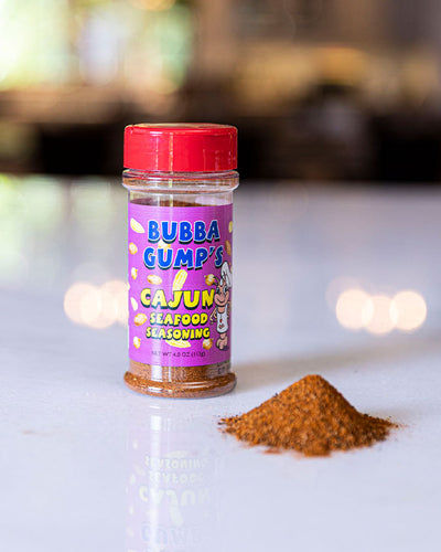 Bubba Gump's Cajun Seafood Seasoning placed on top of table with background blurred out.