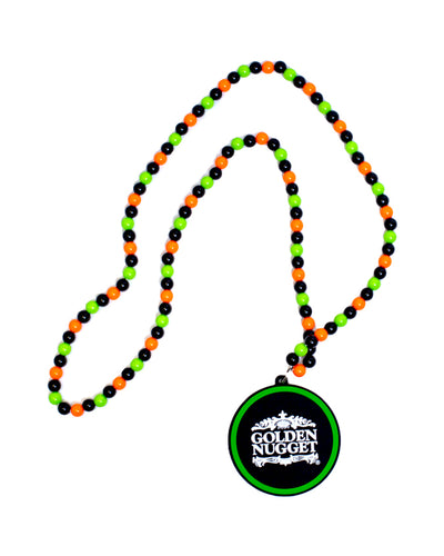 Green, orange, and black beaded necklace with Golden Nugget plastic charm.