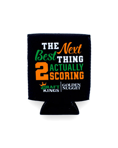 Black drink koozie with "The Next Best Thing 2 Actually Scoring" in orange and green lettering and Draft King/Golden Nugget branding.