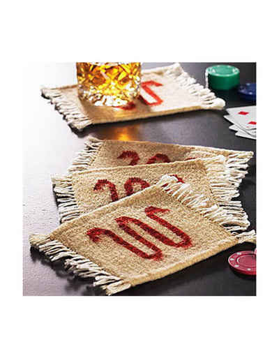 King Ranch Coaster set, 4 beige coasters with red running w in center of each coaster, pictured with Poker chips and cards laid out beside coasters, whiskey glass on furthest coaster.