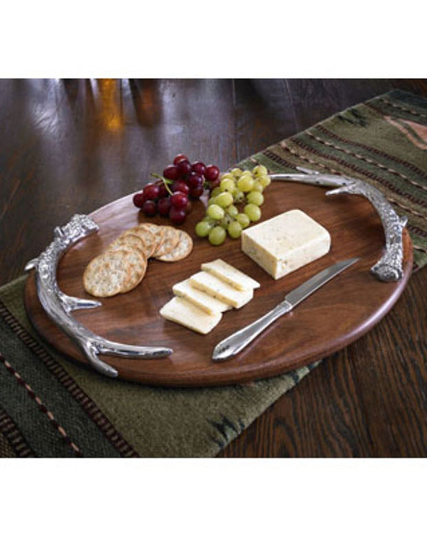 King Ranch wooden Cutting board with petwer casting antler handles for carrying the tray. Pictured with grapes, sliced cheese, crackers a knife.