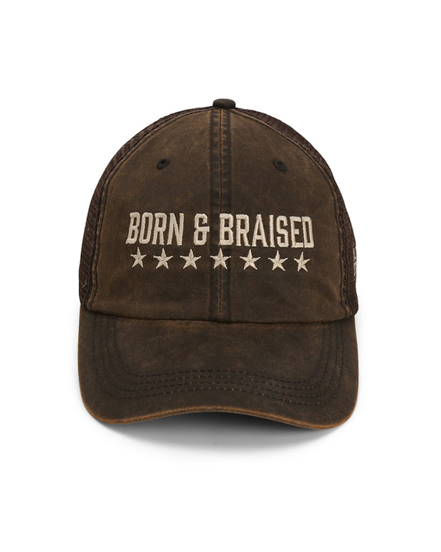 Front view of cap to show embroidery of "Born and Braised" in tan and underlined stars.