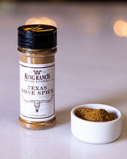 King Ranch Texas Bone Spice on table and sample inside condiment bowl with background blurred.