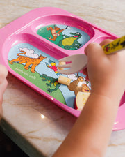 Toddler eating at the table using the Pink Kids Divided Plate and matching print yellow spoon.