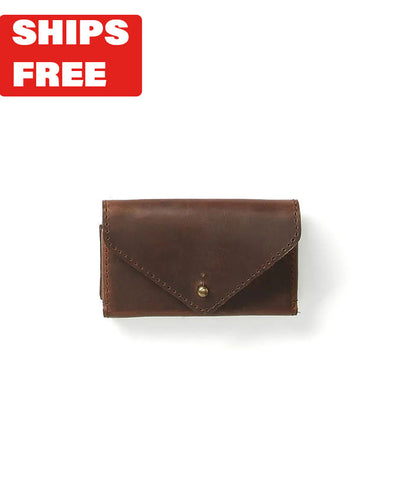 Brown leather business card case in front of white background with red "Ships Free" tag in top corner.