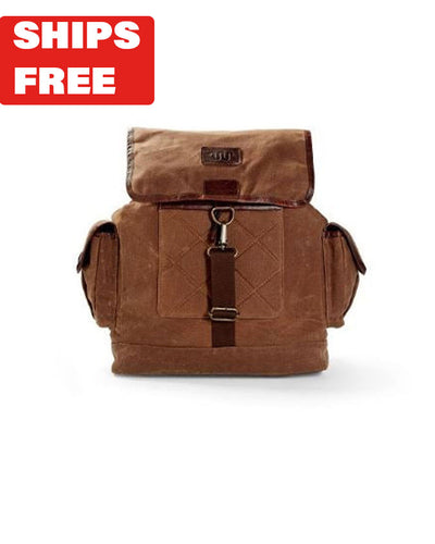 Light brown canvas backpack with side pockets and buckle and King Ranch logo on top with red "Ships Free" tag in top corner.