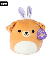 Light brown dog Squishmallow with a smiling face, white tummy, purple polka dot bunny ears, floppy ears, and a black "New" tag in top corner. 