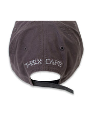 Back of cap with embroidered label that says "T-Rex Cafe" in a bone font and has a strap back.