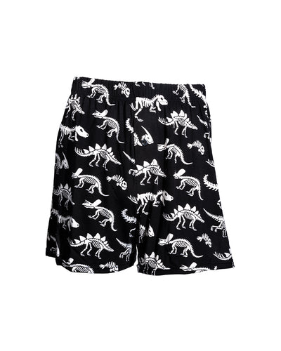 Black boxers with dinosaur skeleton pattern in front of white background.
