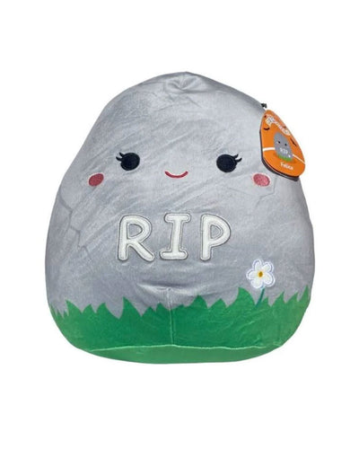 A plush toy designed to look like a tombstone, complete with a cute face and the letters ‘RIP’ written on it.