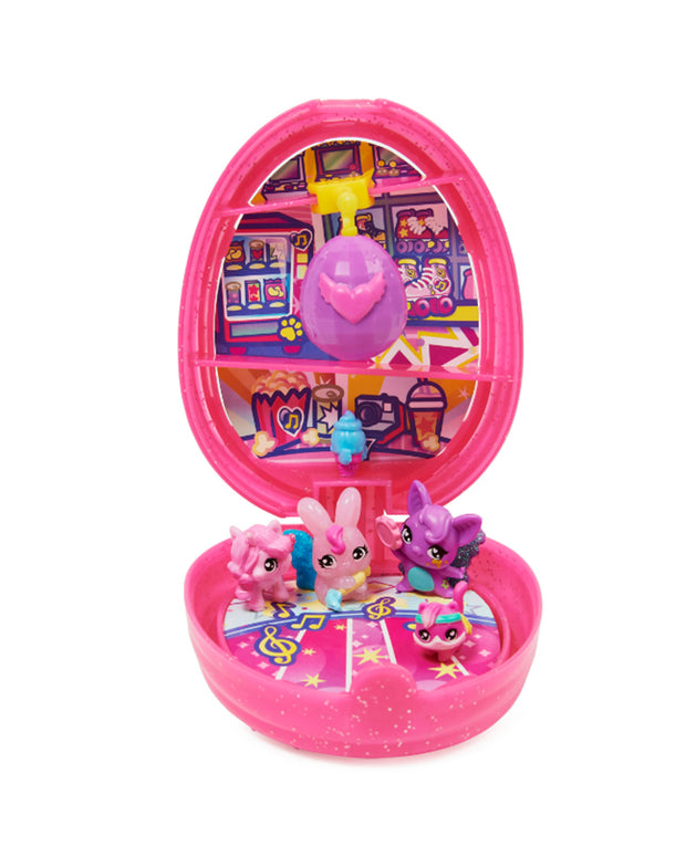 Big pink egg opened up to reveal 4 figurines and small purple egg with Hatchimals backgrounds.