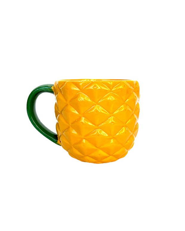 Yellow, pineapple patterned coffee mug with green handle.