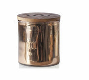Candle with rose gold wrapping and King Ranch logo on lid  in front of white background.