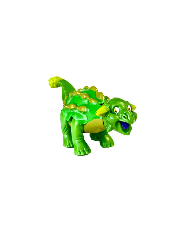 Side view of green and yellow Sebastian the Ankylosaurus in front of white background.