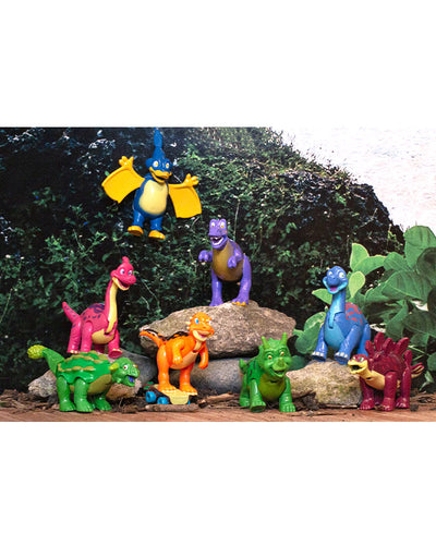 8 T-Rex Cafe character figurines posed in front of a forest background.