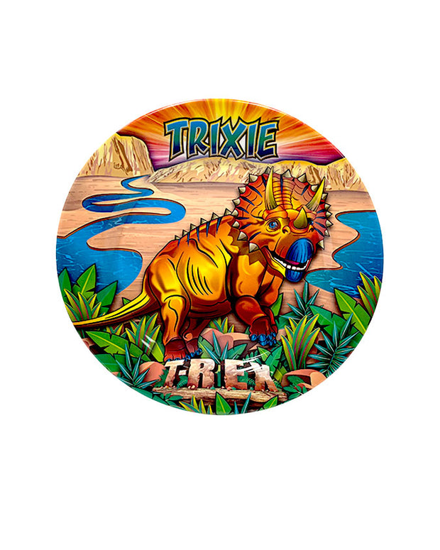 Orange Trixie the Triceratops in front of a vibrant canyon background on plate.